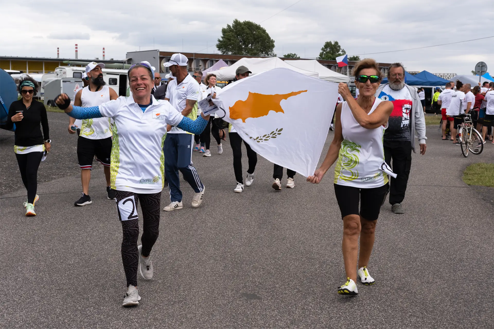 dragon boat cyprus national team paddler walking with flag