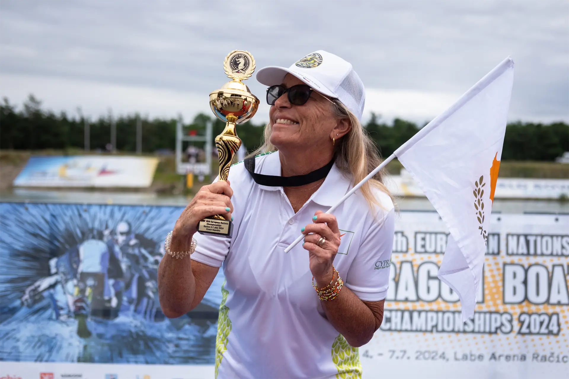 dragon boat cyprus national team female paddler holding trophey